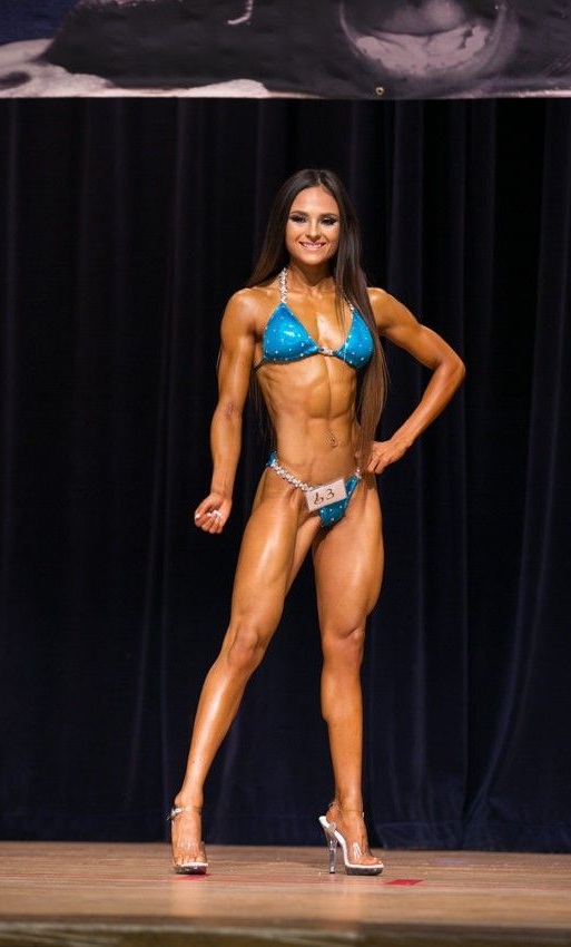 Bikini competitor on stage at an NPC show