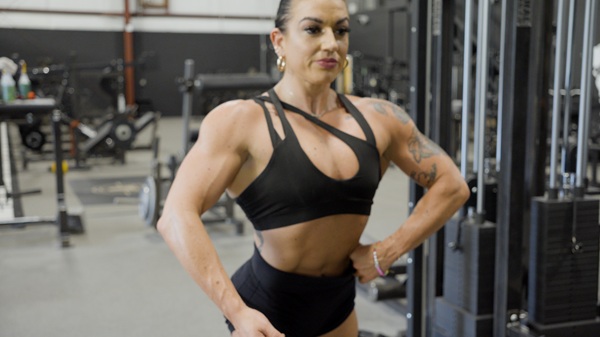 Figure athlete posing in the gym