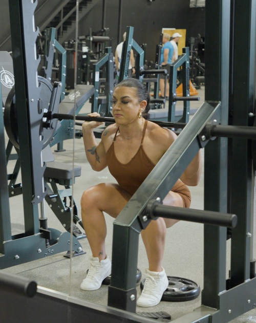 Figure competitor training legs in the gym