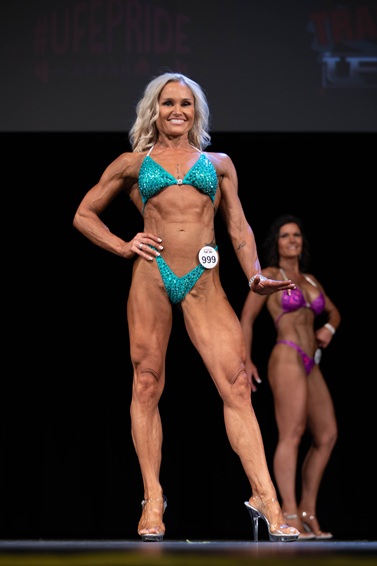 Bikini competitor on stage at an OCB show